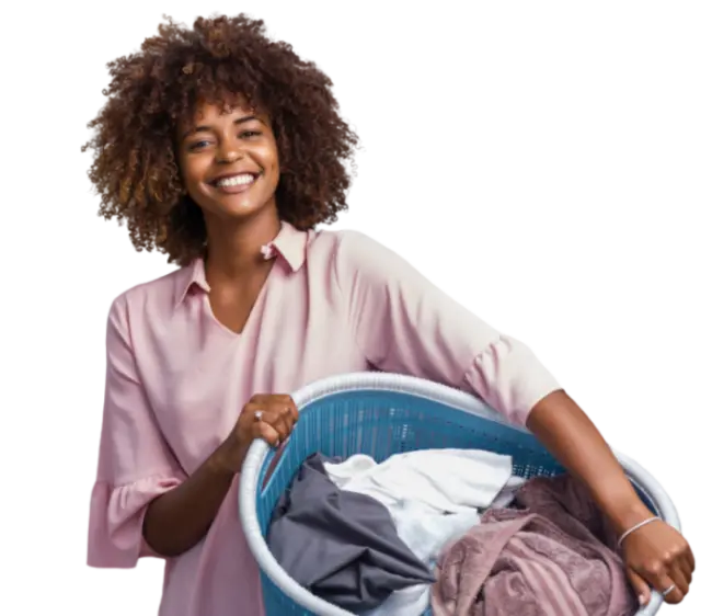 Smiling woman holding a basket of clean clothes representing a professional dry cleaning and laundry service
